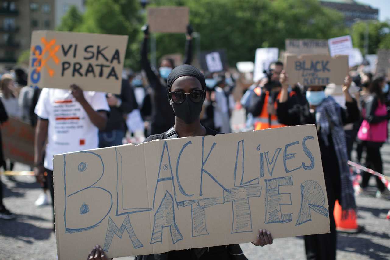 A protestor hold up a sign reading 'Black Lives Matter' at a protest in Gothenburg, Sweden.