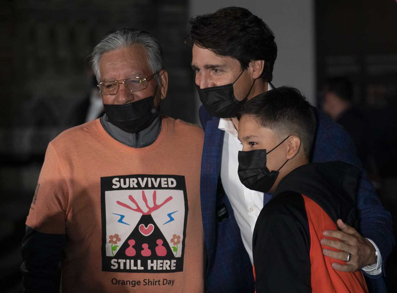 A survivor and family with Justin Trudeau on Parliament Hill on the eve of the first National Day of Truth and Reconciliation, September 29, 2021. (Adrian Wyld/Canadian Press)