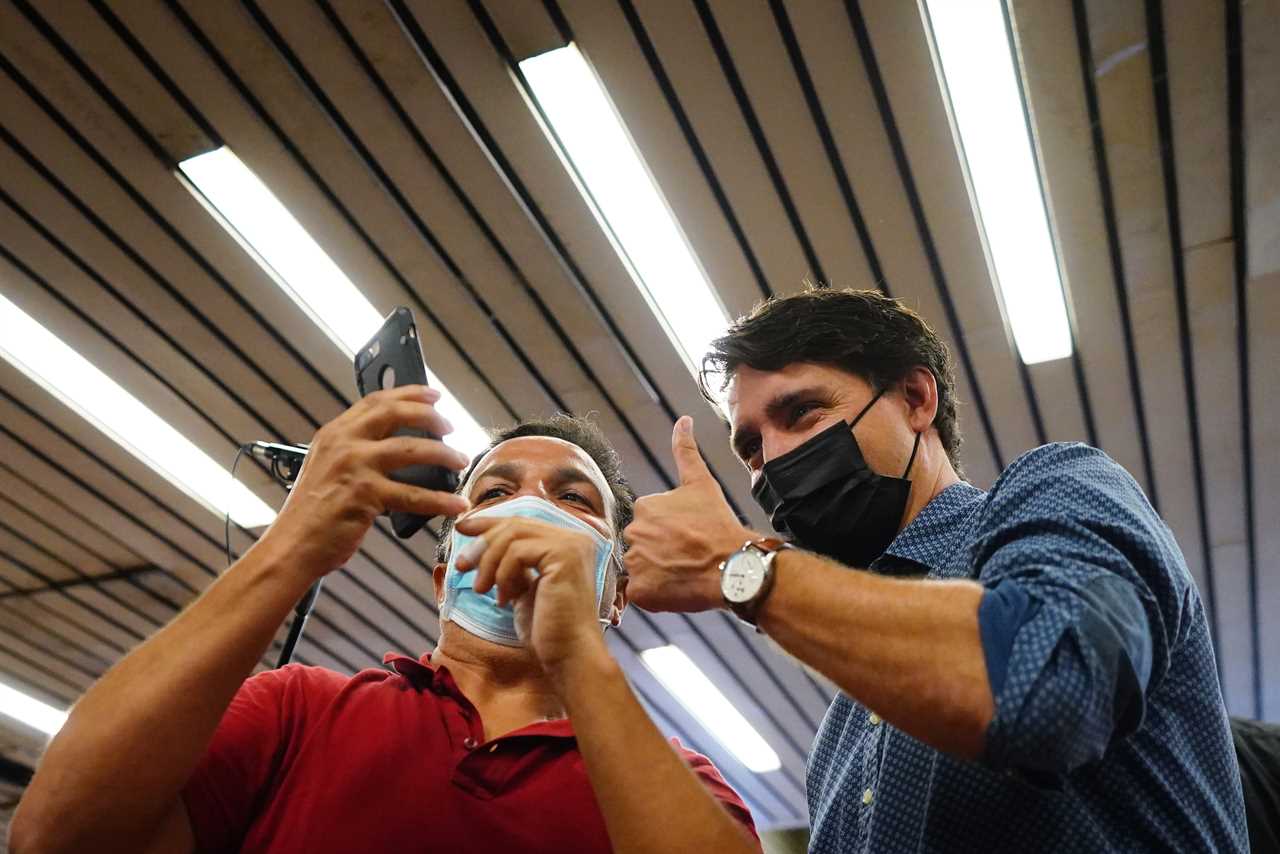 Trudeau poses for a photo as he greets commuters at a Montreal Metro station on Sept. 21, 2021 (Sean Kilpatrick/CP)