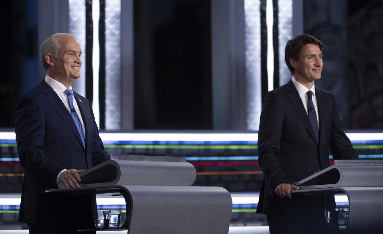 O'Toole and Trudeau smile during the federal election French-language leaders debate on Sept. 8, 2021 in Gatineau, Que. (Justin Tang/CP)