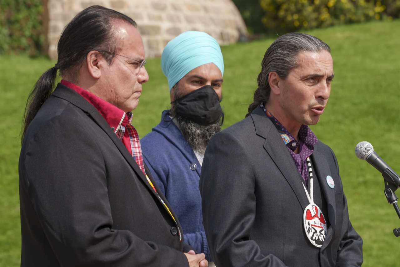 NDP leader Jagmeet Singh and Grand Chief Garrison Settee, left, Manitoba Keewatinowi Okimakanak, listen to Grand Chief Arlen Dumas, right, Assembly of Manitoba Chiefs, following a meeting Manitoba Keewatinowi Okimakanak in Winnipeg, on Thursday, August 26, 2021. (Paul Chiasson/CP)