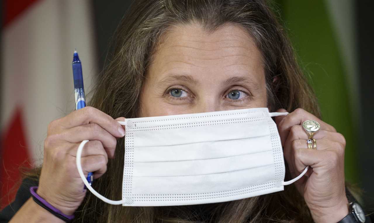 Finance Minister Chrystia Freeland slips on her mask following a news conference in Boisbriand, Que. on Monday, July 19, 2021. THE CANADIAN PRESS/Paul Chiasson