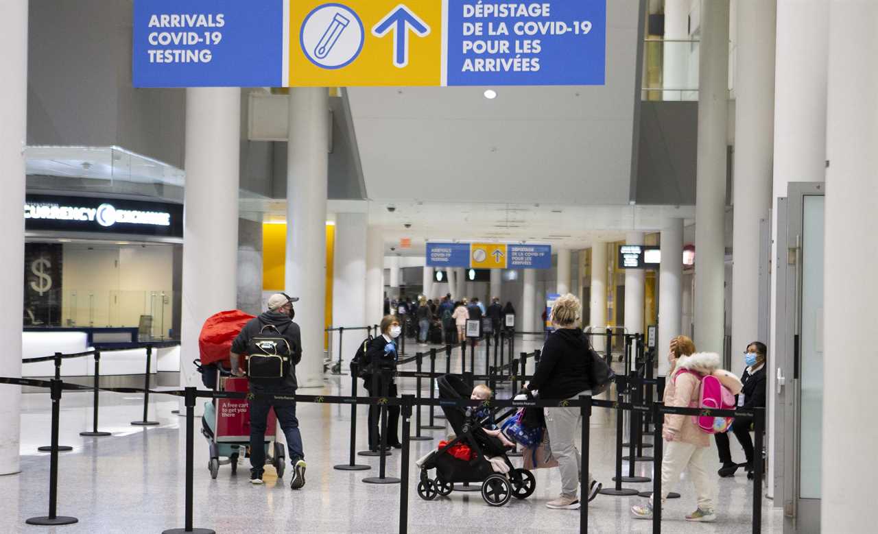 International travellers walk to a COVID-19 testing site after arriving at Toronto Pearson International Airport in Mississauga, Ontario, on Nov. 28, 2021. (Zou Zheng/Xinhua via ZUMA Press)