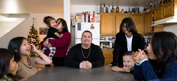 Maria Silva, standing at left, and Orlando Granillo, center, are raising their six children in Las Vegas. The monthly child tax credit allowed the family to pay bills and lease a used car after Orlando lost his job during the pandemic.