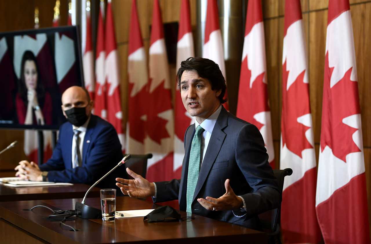 Trudeau speaks as Minister of Health Jean-Yves Duclos and Deputy Prime Minister and Minister of Finance Chrystia Freeland, seen via videoconference, participate in a news conference on the COVID-19 pandemic in Ottawa, Jan. 5, 2022. (Justin Tang/The Canadian Press)