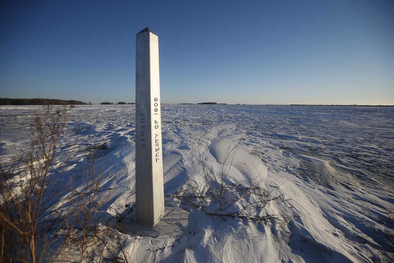 A border marker is shown just outside of Emerson, Man. on Jan. 20, 2022. American investigators believe the deaths of four people, including a baby and a teen, whose bodies were found in Manitoba near the United States border are linked to a larger human smuggling operation. (John Woods/The Canadian Press)