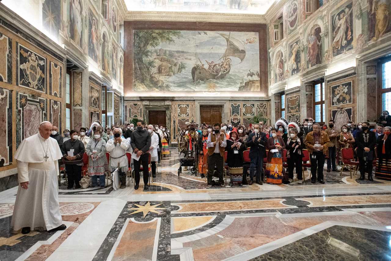 The final audience stands with Pope Francis and members of the Indigenous delegation where the Pontiff delivered an apology for the Catholic Church’s role in Canada's residential school system, at the Vatican, April 1, 2022. (THE CANADIAN PRESS/HO-Vatican Media)